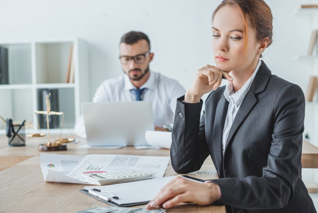 accountants working in office with documents and laptop